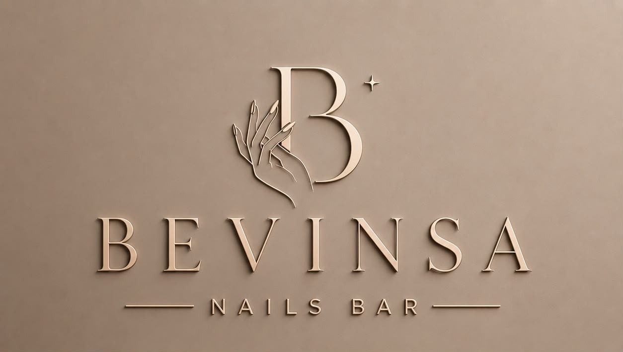 BEVINSA Nails Bar, engraved gold logo with a delicate hand-and-nails monogram on a soft taupe wall
